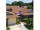 Charming home featuring meticulously maintained landscaping, and an American flag at 5512 Rosewall Cir, Leesburg, FL 34748
