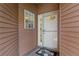 Welcoming entrance featuring a charming window and storm door at 5512 Rosewall Cir, Leesburg, FL 34748