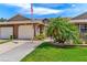 Charming home featuring meticulously maintained landscaping, and an American flag at 5512 Rosewall Cir, Leesburg, FL 34748