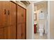 Hallway with built in wood cabinets leading to a bathroom at 5512 Rosewall Cir, Leesburg, FL 34748