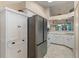 Well-equipped kitchen with stainless steel refrigerator and open view to the main living areas at 5512 Rosewall Cir, Leesburg, FL 34748