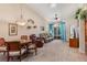 Bright living room with vaulted ceilings, a ceiling fan, and access to the outdoors via sliding glass doors at 5512 Rosewall Cir, Leesburg, FL 34748