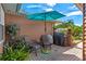 Inviting outdoor patio space with comfortable seating and a charming teal umbrella at 5512 Rosewall Cir, Leesburg, FL 34748
