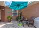 Inviting outdoor patio space with comfortable seating and a charming teal umbrella at 5512 Rosewall Cir, Leesburg, FL 34748