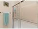 Close-up of a glass shower with a towel bar and a neutral color scheme at 5512 Rosewall Cir, Leesburg, FL 34748