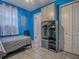 Blue bedroom featuring bed, shoe storage, and white closets at 564 Lancaster Ave, Orange City, FL 32763