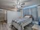 Bedroom features wood-look floors, neutral walls, and a large window letting in natural light at 564 Lancaster Ave, Orange City, FL 32763