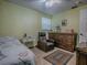 This bedroom features a twin bed, dresser, recliner, and neutral tile floors at 564 Lancaster Ave, Orange City, FL 32763