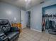 Bedroom featuring a recliner, a closet and tile floors at 564 Lancaster Ave, Orange City, FL 32763