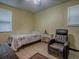 Cozy bedroom featuring a twin bed, recliner, and natural light from a window at 564 Lancaster Ave, Orange City, FL 32763