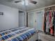This bedroom has wood-look floors, double doors, and a rack with assorted clothing at 564 Lancaster Ave, Orange City, FL 32763