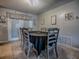 Cozy dining room with tile floors, decor, and seating for six with a black tablecloth at 564 Lancaster Ave, Orange City, FL 32763