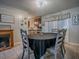 Cozy dining area featuring a fireplace, round table with seating for six, and easy access to the kitchen at 564 Lancaster Ave, Orange City, FL 32763