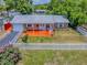 Charming single-story home featuring a brick facade, white picket fence, and a vibrant, welcoming front porch at 564 Lancaster Ave, Orange City, FL 32763