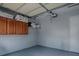 Interior of an empty garage with cabinets, shelves, and a white door at 564 Lancaster Ave, Orange City, FL 32763