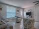 Bright living room featuring tile flooring, comfortable seating, and a view of the front door at 564 Lancaster Ave, Orange City, FL 32763