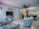 Open living area with tile flooring, ceiling fan, and views to the kitchen and dining at 564 Lancaster Ave, Orange City, FL 32763
