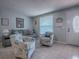 Inviting living room featuring tile flooring, cozy seating, and ample natural light at 564 Lancaster Ave, Orange City, FL 32763