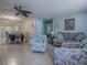 Cozy living room features tile flooring, blue-themed furniture, and a ceiling fan at 564 Lancaster Ave, Orange City, FL 32763