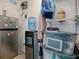 Organized storage area with shelving, refrigerator, and water cooler for convenience at 564 Lancaster Ave, Orange City, FL 32763