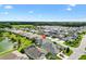 Expansive aerial view of the community, showcasing the home's location near a pond and green spaces at 5746 Botner Dr, The Villages, FL 32163