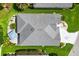Aerial view of a well-maintained house with a patio and lush landscaping at 5746 Botner Dr, The Villages, FL 32163