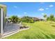 Beautiful backyard featuring a patio, lush landscaping, and a well-maintained lawn at 5746 Botner Dr, The Villages, FL 32163