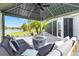 Backyard patio showcasing outdoor furniture, a fire pit, lovely landscaping, and a water view at 5746 Botner Dr, The Villages, FL 32163