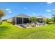 Beautiful backyard featuring patio and gazebo, lush landscaping, and a well-maintained lawn at 5746 Botner Dr, The Villages, FL 32163
