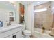 Coastal bathroom with a white vanity, shutter-style decor, and a shower-tub combination at 5746 Botner Dr, The Villages, FL 32163
