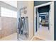 Bathroom featuring a tiled walk-in shower and a doorway view of the main bedroom at 5746 Botner Dr, The Villages, FL 32163