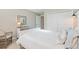 Bright bedroom featuring white furniture, neutral walls, and a cozy seating area at 5746 Botner Dr, The Villages, FL 32163