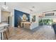 Dining area with blue accent wall, decorative mirror, and sliding doors to outdoor space at 5746 Botner Dr, The Villages, FL 32163