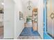 Bright and airy entryway with a patterned rug and views into the dining area and backyard at 5746 Botner Dr, The Villages, FL 32163