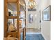 Bright entryway featuring a decorative chandelier, attractive flooring and a glimpse of the front door at 5746 Botner Dr, The Villages, FL 32163