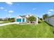 Lovely single-story home has beautiful landscaping with lush green lawns and a three-car garage at 5746 Botner Dr, The Villages, FL 32163