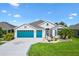 Charming single-story home with a three-car garage and well-manicured lawn and attractive landscaping at 5746 Botner Dr, The Villages, FL 32163