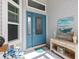 Inviting front entryway with a blue front door, decorative windows, and coordinated decor at 5746 Botner Dr, The Villages, FL 32163