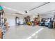Spacious and well-lit garage with storage cabinets, work area, and a golf cart at 5746 Botner Dr, The Villages, FL 32163