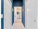 Hallway view leading to a well-lit bathroom with a double vanity and modern finishes at 5746 Botner Dr, The Villages, FL 32163