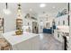 Bright, open kitchen features white cabinetry, a quartz countertop island, and stainless steel appliances at 5746 Botner Dr, The Villages, FL 32163