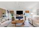 Inviting living room with electric fireplace, shiplap accent wall, and decorative coastal elements at 5746 Botner Dr, The Villages, FL 32163
