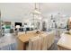 Open floor plan of the living room and dining area; coastal decor throughout at 5746 Botner Dr, The Villages, FL 32163
