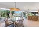 Light-filled sunroom featuring floor-to-ceiling windows and views of the lake at 5746 Botner Dr, The Villages, FL 32163