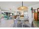 Bright sunroom featuring a glass table, wicker chairs, and coastal decor for relaxed dining and lounging at 5746 Botner Dr, The Villages, FL 32163
