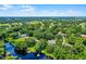 Aerial view of the property near the lake with mature trees and docks in the surrounding area at 5825 Lake Emma Ct, Groveland, FL 34736