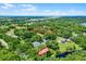 Aerial view of the property with lush greenery, nearby boat launch, and neighborhood amenities at 5825 Lake Emma Ct, Groveland, FL 34736