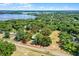 Aerial view with property boundary features lush trees, blue shed and road, perfect for an overview of the lot at 5825 Lake Emma Ct, Groveland, FL 34736
