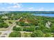 Expansive aerial view of a lot surrounded by trees and close to lakes and other community amenities at 5825 Lake Emma Ct, Groveland, FL 34736