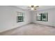 Neutral bedroom provides natural light with large windows, creating a calm and relaxing atmosphere at 5825 Lake Emma Ct, Groveland, FL 34736
